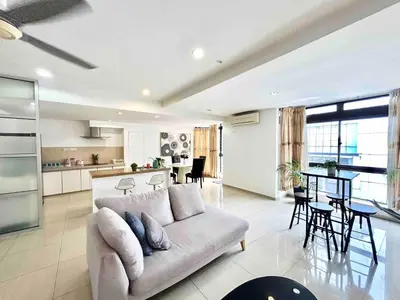 a living room and kitchen with a couch and a table at LATEST facing Pavilion main entrance in Kuala Lumpur