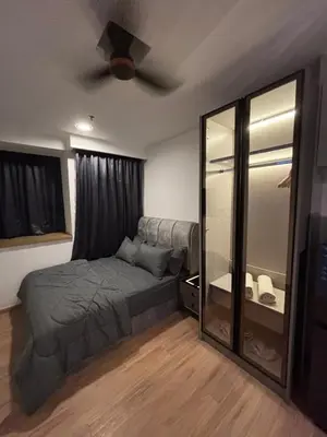 a bedroom with a bed and a ceiling fan at Riveria City in Kuala Lumpur