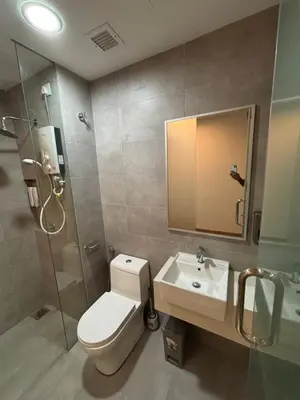 a bathroom with a toilet and a sink and a shower at Riveria City in Kuala Lumpur
