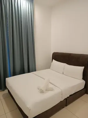 a bed in a room next to a curtain at Trion Residence Kuala Lumpur by Azure in Kuala Lumpur