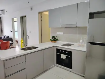 a kitchen with white cabinets and a sink at Trion Residence Kuala Lumpur by Azure in Kuala Lumpur