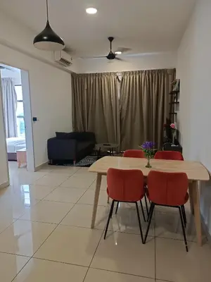 a dining room with a table and red chairs at Trion Residence Kuala Lumpur by Azure in Kuala Lumpur
