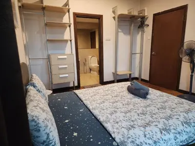 a bedroom with a large bed and a closet at Regalia residence KLCC By Glory Homes in Kuala Lumpur