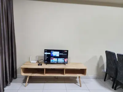 a wooden desk with a computer on top of it at Regalia residence KLCC By Glory Homes in Kuala Lumpur