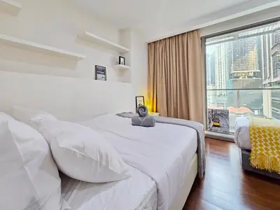 a bedroom with a large bed and a large window at Bukit Bintang Fairlane Residence #81 Pavilion Kuala Lumpur in Kuala Lumpur