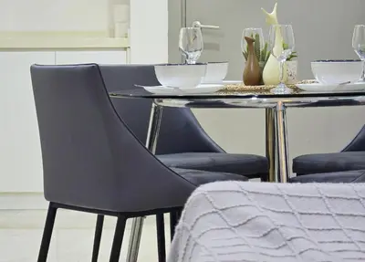 a dining table with two chairs and a table with wine glasses at Bukit Bintang Fairlane Residence #81 Pavilion Kuala Lumpur in Kuala Lumpur