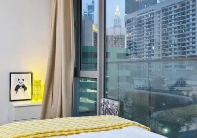 a bedroom with a bed and a large window at Bukit Bintang Fairlane Residence #81 Pavilion Kuala Lumpur in Kuala Lumpur