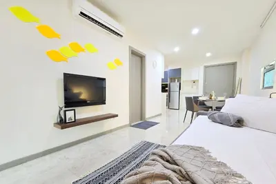 a bedroom with a bed and a tv on a wall at Bukit Bintang Fairlane Residence #81 Pavilion Kuala Lumpur in Kuala Lumpur