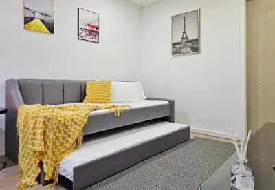a bed with a yellow blanket on it in a room at Bukit Bintang Fairlane Residence #199 KL TRX Pavilion in Kuala Lumpur
