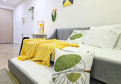 a bedroom with a couch and a bed with a blanket at Bukit Bintang Fairlane Residence #199 KL TRX Pavilion in Kuala Lumpur