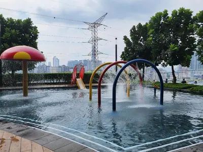 a pool of water with a water slide at Family Suite M Vertica Sunway Velocity Ikea KL MRT in Kuala Lumpur
