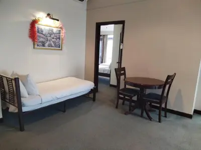 a room with a bench and a table and a mirror at KL Marigold Apartment At Times Square in Kuala Lumpur