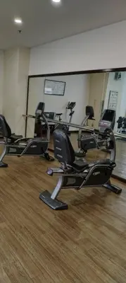 a gym with several elliptical machines in a room at KL Marigold Apartment At Times Square in Kuala Lumpur