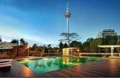 a large swimming pool in a park at night at Luxury Balcony Suites- Homestay in Kuala Lumpur