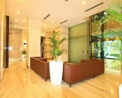 a lobby with a potted plant in the middle at Luxury Balcony Suites- Homestay in Kuala Lumpur