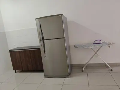 a stainless steel refrigerator in a kitchen with a table at 2 Rooms Apartment at Kuala Lumpur in Kuala Lumpur