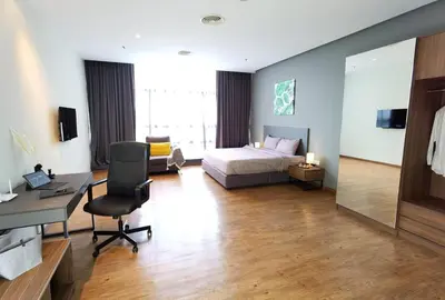 a hotel room with a bed and a desk and a desk at The Adina - Bangsar Trade Centre in Kuala Lumpur