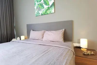 a bedroom with a large white bed with two lamps at The Adina - Bangsar Trade Centre in Kuala Lumpur