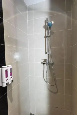 a shower with a shower head in a bathroom at The Adina - Bangsar Trade Centre in Kuala Lumpur
