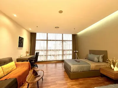 a bedroom with a bed and a couch and a desk at The Teak - Bangsar Trade Centre in Kuala Lumpur