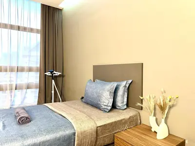a bedroom with a bed and a window at The Teak - Bangsar Trade Centre in Kuala Lumpur