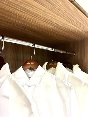 a pile of white clothes hanging on a rack at The Teak - Bangsar Trade Centre in Kuala Lumpur