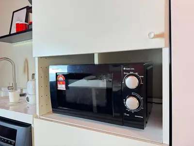 a microwave oven in the middle of a kitchen at The Trigo - Bangsar Trade Centre in Kuala Lumpur