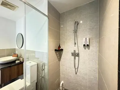 a bathroom with a shower and a sink at The Trigo - Bangsar Trade Centre in Kuala Lumpur