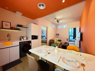 a kitchen and living room with a white table and chairs at The Trigo - Bangsar Trade Centre in Kuala Lumpur