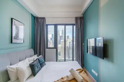 a bedroom with a bed and a large window at The Colony & Luxe Kuala Lumpur with Skypool by Cobnb in Kuala Lumpur