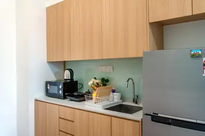 a kitchen with a sink and a refrigerator at The Colony & Luxe Kuala Lumpur with Skypool by Cobnb in Kuala Lumpur