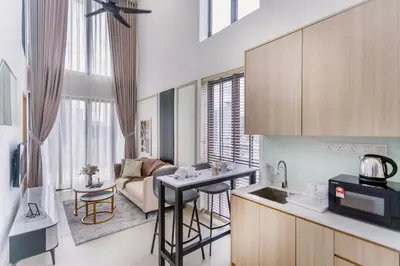 a kitchen and a living room with a couch at The Colony & Luxe Kuala Lumpur with Skypool by Cobnb in Kuala Lumpur