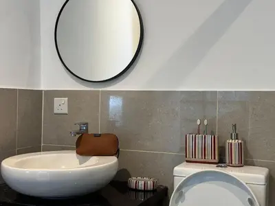 a bathroom with a sink and a mirror on the wall at The Benton - Bangsar Trade Centre in Kuala Lumpur