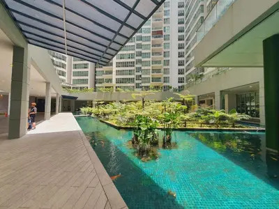 a building with a pool in the middle of a building at Stay at Regalia KLCC View Sky Pool in Kuala Lumpur