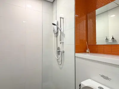 a bathroom with a shower and a toilet at Arcoris Mont Kiara FaceHome in Kuala Lumpur