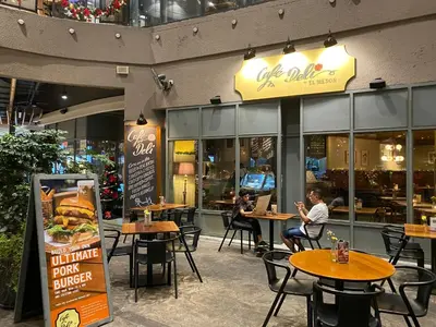 two people sitting at tables in a restaurant at Arcoris Mont Kiara FaceHome in Kuala Lumpur