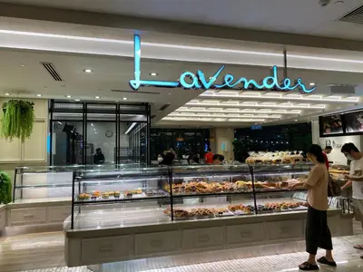 a bakery with people standing in front of a display case at Arcoris Mont Kiara FaceHome in Kuala Lumpur
