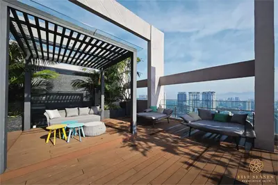 a deck with couches and tables on a building at Riveria Signature Suites, KL Sentral in Kuala Lumpur