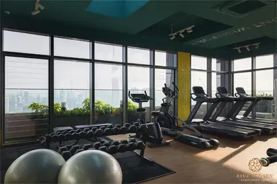 a gym with chairs and treadmills in a building at Riveria Signature Suites, KL Sentral in Kuala Lumpur