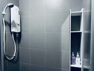 a bathroom with a shower with a phone on the wall at Summer Suites KLCC by EASY STAY in Kuala Lumpur