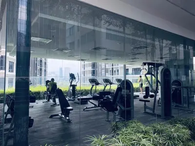 a gym with treadmills and chairs in a building at Summer Suites KLCC by EASY STAY in Kuala Lumpur