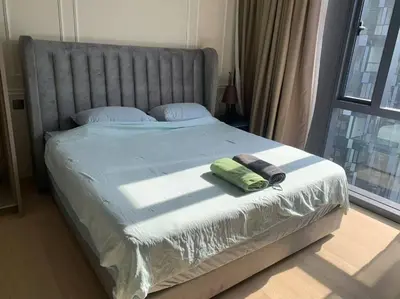 a bed with a green towel on it with a window at Star Residence 1R1B KLCC in Kuala Lumpur