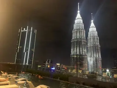 a view of the petronas twin towers at night at Star Residence 1R1B KLCC in Kuala Lumpur