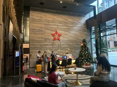 a group of people in a lobby with a christmas tree at Star Residence 1R1B KLCC in Kuala Lumpur