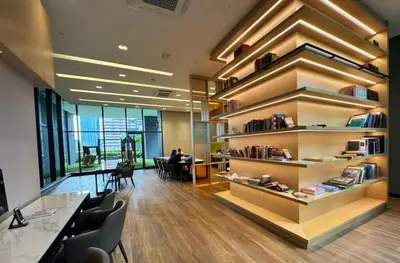 an office with a library with a table and chairs at Star Residence 1R1B KLCC in Kuala Lumpur