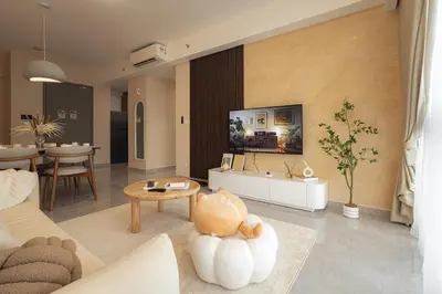 a living room with a couch and a tv on a wall at Agile Bukit Bintang in Kuala Lumpur