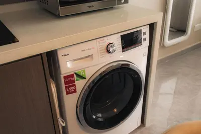 a washing machine under a counter in a kitchen at Agile Bukit Bintang in Kuala Lumpur