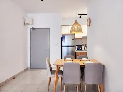 a kitchen with a wooden table and chairs at Flora Residency KL -- Botanical Vibes #3BR2B #1-7 pax by Cowidea in Kuala Lumpur