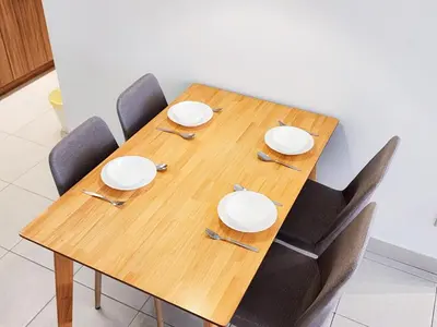 a wooden table with chairs and plates and silverware at Flora Residency KL -- Botanical Vibes #3BR2B #1-7 pax by Cowidea in Kuala Lumpur