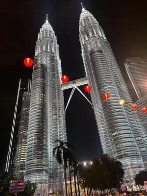 two large skyscrapers in a city at night at URBAN SKY HOME NEAR KLCC Complementary Breakfast in Kuala Lumpur